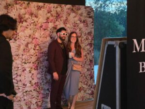 Wedding guests posing for photos during Jordan and Tyler's Mirror Photo Booth experience